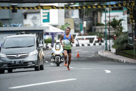 Yogyakarta, Indonesia - October 30, 2022 : running participants who pass through the streets of the city of Yogyakarta, they take part in the "Klik Dokter Run Fest 2022" running competition.のeditorial素材