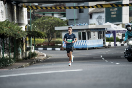 Yogyakarta, Indonesia - October 30, 2022 : running participants who pass through the streets of the city of Yogyakarta, they take part in the "Klik Dokter Run Fest 2022" running competition.のeditorial素材
