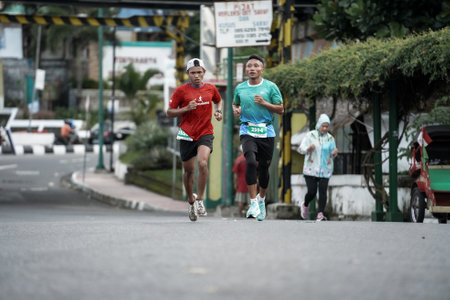 Yogyakarta, Indonesia - October 30, 2022 : running participants who pass through the streets of the city of Yogyakarta, they take part in the "Klik Dokter Run Fest 2022" running competition.のeditorial素材