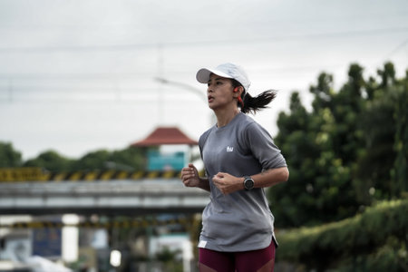 Yogyakarta, Indonesia - October 30, 2022 : running participants who pass through the streets of the city of Yogyakarta, they take part in the "Klik Dokter Run Fest 2022" running competition.のeditorial素材