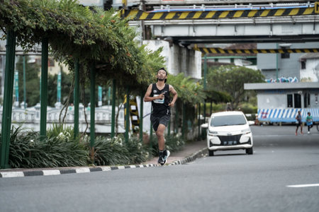 Yogyakarta, Indonesia - October 30, 2022 : running participants who pass through the streets of the city of Yogyakarta, they take part in the "Klik Dokter Run Fest 2022" running competition.のeditorial素材