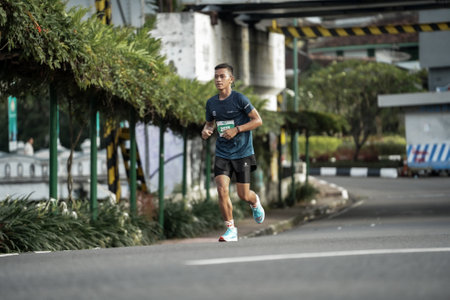 Yogyakarta, Indonesia - October 30, 2022 : running participants who pass through the streets of the city of Yogyakarta, they take part in the "Klik Dokter Run Fest 2022" running competition.のeditorial素材