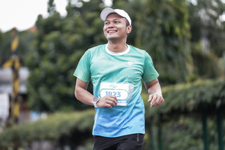 Yogyakarta, Indonesia - October 30, 2022 : running participants who pass through the streets of the city of Yogyakarta, they take part in the "Klik Dokter Run Fest 2022" running competition.のeditorial素材
