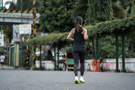 Yogyakarta, Indonesia - October 30, 2022 : running participants who pass through the streets of the city of Yogyakarta, they take part in the "Klik Dokter Run Fest 2022" running competition.のeditorial素材