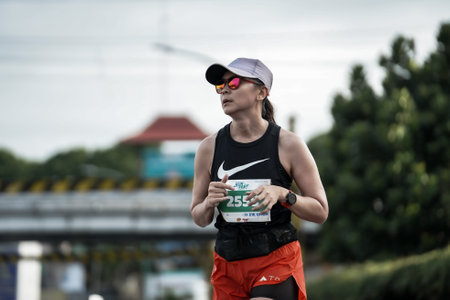 Yogyakarta, Indonesia - October 30, 2022 : running participants who pass through the streets of the city of Yogyakarta, they take part in the "Klik Dokter Run Fest 2022" running competition.のeditorial素材