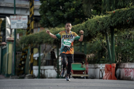 Yogyakarta, Indonesia - October 30, 2022 : running participants who pass through the streets of the city of Yogyakarta, they take part in the "Klik Dokter Run Fest 2022" running competition.のeditorial素材