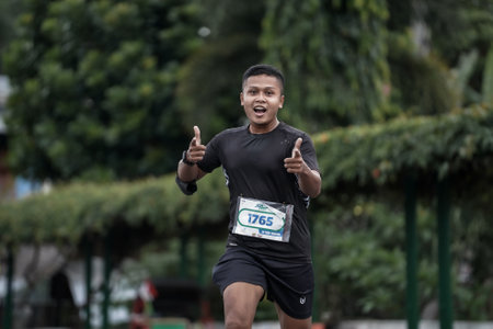 Yogyakarta, Indonesia - October 30, 2022 : running participants who pass through the streets of the city of Yogyakarta, they take part in the "Klik Dokter Run Fest 2022" running competition.のeditorial素材