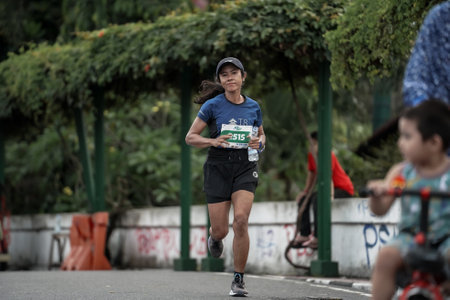Yogyakarta, Indonesia - October 30, 2022 : running participants who pass through the streets of the city of Yogyakarta, they take part in the "Klik Dokter Run Fest 2022" running competition.のeditorial素材