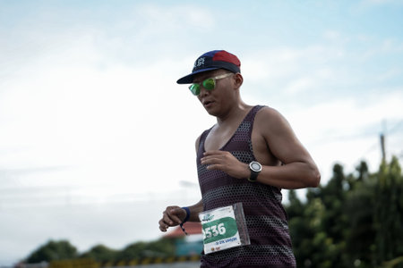 Yogyakarta, Indonesia - October 30, 2022 : running participants who pass through the streets of the city of Yogyakarta, they take part in the "Klik Dokter Run Fest 2022" running competition.のeditorial素材