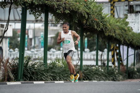 Yogyakarta, Indonesia - October 30, 2022 : running participants who pass through the streets of the city of Yogyakarta, they take part in the "Klik Dokter Run Fest 2022" running competition.のeditorial素材