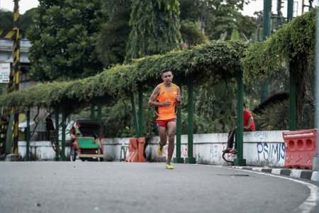 Yogyakarta, Indonesia - October 30, 2022 : running participants who pass through the streets of the city of Yogyakarta, they take part in the "Klik Dokter Run Fest 2022" running competition.のeditorial素材