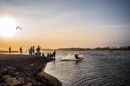 sports photographer documenting kitesurfing, surfers in action with sunset view. : Yogyakarta, Indonesia - 26 August 2023のeditorial素材
