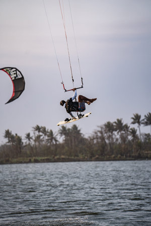 kitesurfing. A surfer doing all kinds of stunts at sunset. International Kitesurfing Exhibition 2023. : Yogyakarta, Indonesia - 26 August 2023のeditorial素材