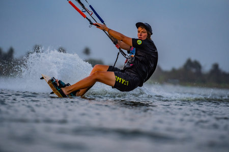 kitesurfing. A surfer rides against a backdrop of beautiful bridges and coastlines and performs all...