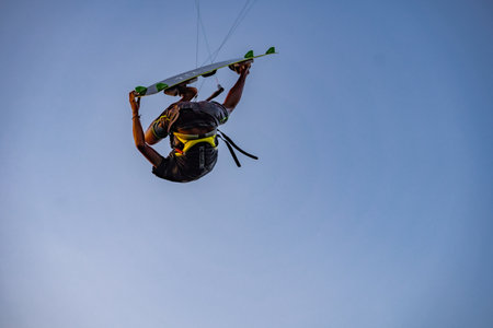 kitesurfing. A surfer doing all kinds of stunts at sunset. International Kitesurfing Exhibition 2023. : Yogyakarta, Indonesia - 26 August 2023のeditorial素材