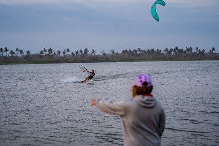 a friend saw a friend who was kitesurfing in the lagoon. : Yogyakarta, Indonesia - 26 August 2023のeditorial素材