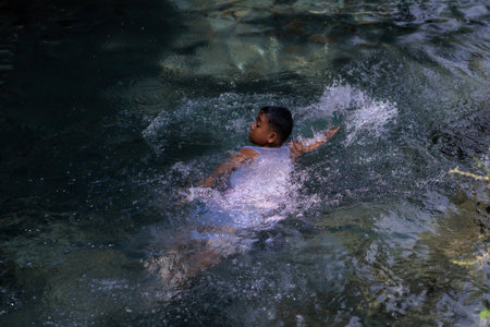 tourists swim in a clean river. Udal Gumuk River, Magelang, Central Java, Indonesia. : Magelang, Indonesia - 31 August 2023のeditorial素材