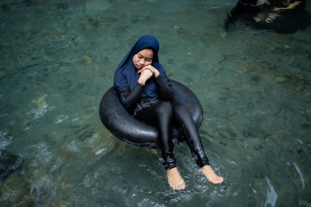 tourists play and enjoy swimming as well as using float tubes, being in the spring river. Udal Gumuk...
