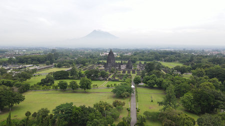 Morning aerial view of the Prambanan temple area in Yogyakarta, with the majestic Mount Merapi...