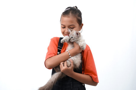 a little asian girl holding a kitten with love, cute. Isolated on white background. international cat day photo concept.の写真素材
