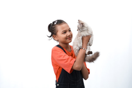 Asian girl holding a cute, adorable and funny kitten. Isolated on white background. International cat day concept.の写真素材