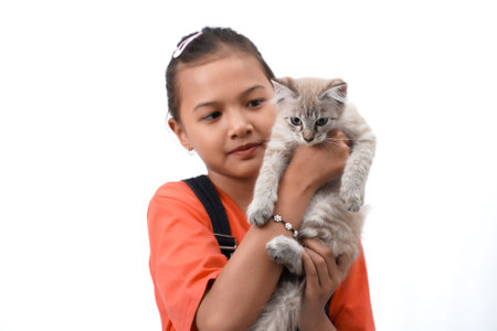 a little asian girl holding a kitten with love, cute. Isolated on white background. international cat day photo concept.の写真素材
