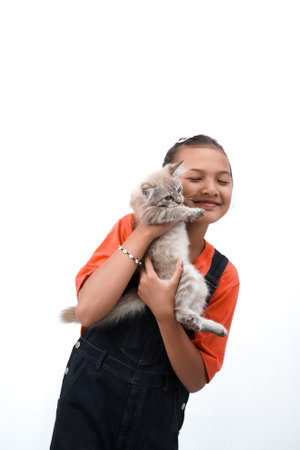 a little asian girl holding a kitten with love, cute. Isolated on white background. international cat day photo concept.の写真素材