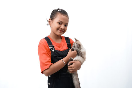 a little girl holding a kitten with love, cute. Isolated on white background. international cat day photo concept.の写真素材
