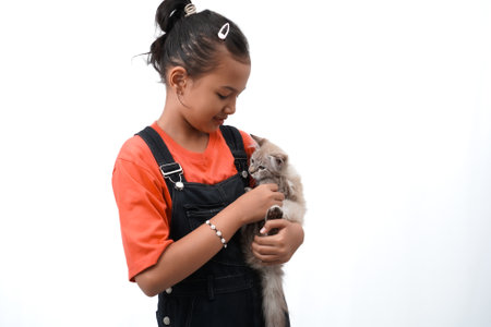 a little asian girl holding a kitten with love, cute. Isolated on white background. international cat day photo concept.の写真素材