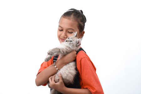 a little asian girl holding a kitten with love, cute. Isolated on white background. international cat day photo concept.の写真素材