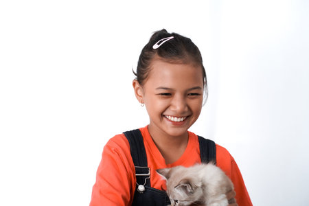 happy expression of asian girl holding cute kitten. Isolated on white background. International cat day concept.の写真素材