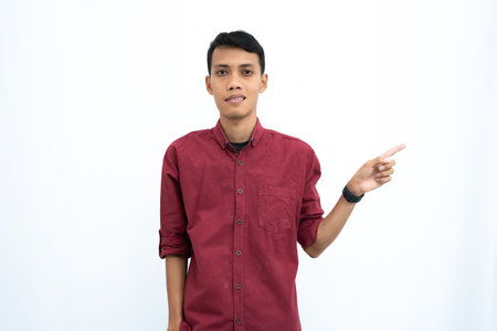 asian man, businessman or student concept wearing red casual shirt posing looking to the side of copy space with happy or surprised face. Isolated white background.の写真素材