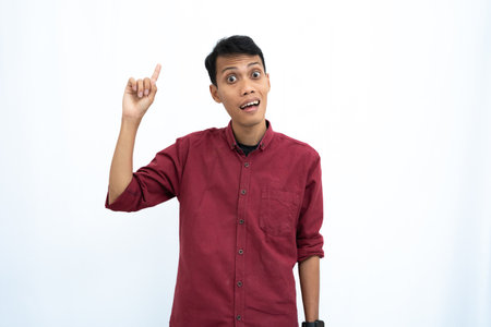 asian man, business or student concept wearing red casual shirt thinking pose, looking for ideas, getting ideas, confused. Isolated white background.の写真素材