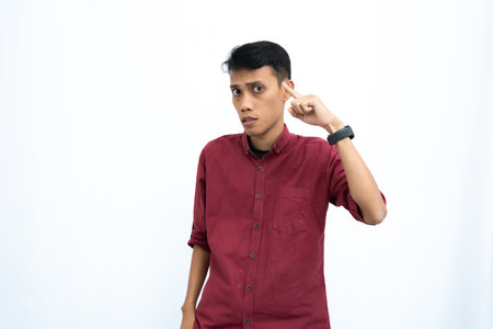 asian man, business or student concept wearing red casual shirt thinking pose, looking for ideas, getting ideas, confused. Isolated white background.の写真素材