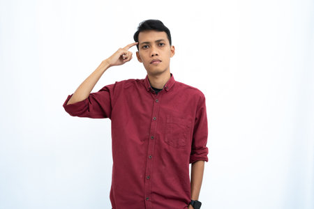 asian man, business or student concept wearing red casual shirt thinking pose, looking for ideas, getting ideas, confused. Isolated white background.の写真素材