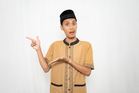 A young man wearing a traditional outfit and cap gesturing with his hands