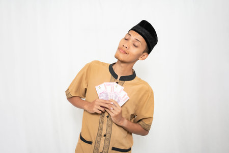 Asian man in ethnic wear with banknotes