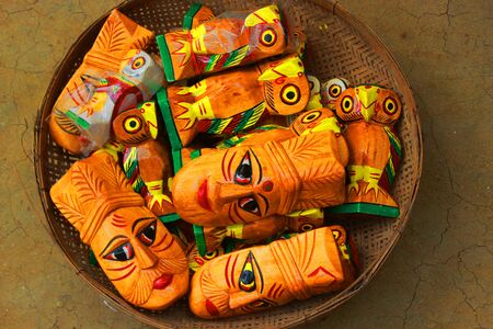 Stack of colored face toys made of woods assemble in a basketの写真素材