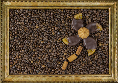 Coffee beans on wooden background in the picture frame in the center on the table top view marmalade gingerbreadの写真素材