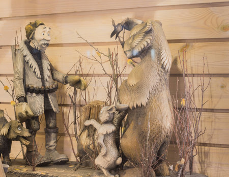 Storefront. Composition of wood - hunter with gun, dog, bear and rabbit in nature. Saint Petersburgの写真素材