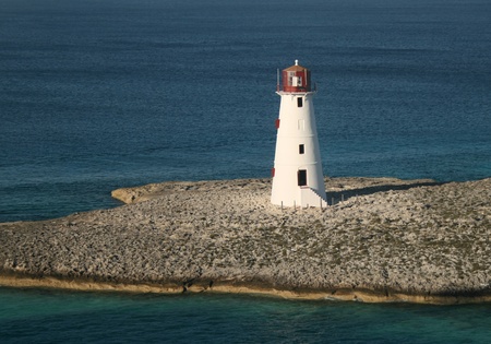 A lighthouse sits at the entrance to a Caribbean port.の写真素材