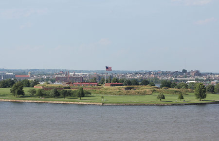 An offshore view of the historic Fort McHenry in the harbor entrance to the city of Baltimore Maryland, USA.  The American national anthem, The Star Spangled Banner, was written by lawyer and amateur poet, Francis Scott Key, a prisoner aboard a British shの写真素材