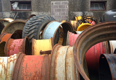 Backyard filled with rusty wheel rims