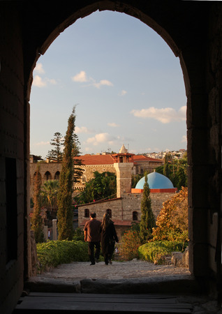 28 September 2018 - Byblos, Lebanon: A couple walks out of the castle in Byblos, Lebanon, before sunsetの写真素材