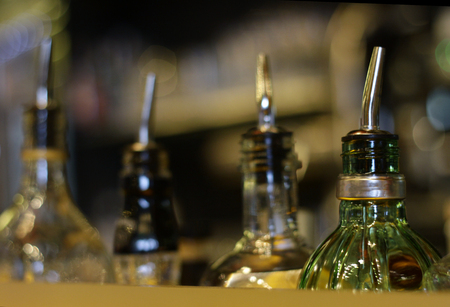 Bottles of gin and vodka lined up in a barの写真素材