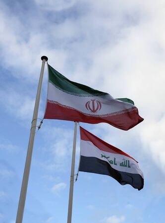 National flags of Iran and Iraq waving in the windの写真素材