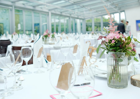 Made tables with flowers and wineglasses