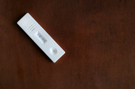 Coronavirus (COVID-19) rapid test with positive result on a tableの写真素材