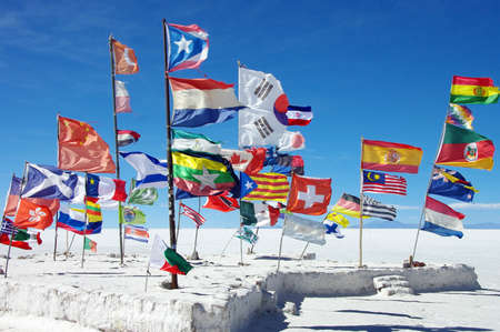 Various national flags in the salt flats of Uyuni, Boliviaの写真素材