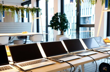 Row of laptops being prepared and set up for new employees in a companyの写真素材